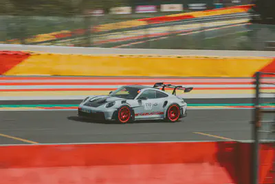 Prosche 911 GT3RS. Photo by [Brecht Denil](https://unsplash.com/@brechtdenil?utm_source=unsplash&utm_medium=referral&utm_content=creditCopyText) on [Unsplash](https://unsplash.com/photos/a-white-race-car-speeds-around-a-track-5M_GM_9fg9Y?utm_source=unsplash&utm_medium=referral&utm_content=creditCopyText)